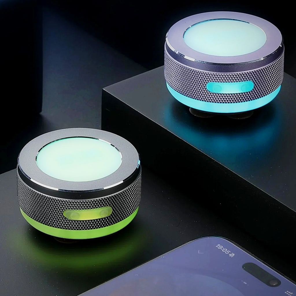 SONVEX Pulse Mini Surface Speaker with glowing RGB light rings, two units on a dark desk