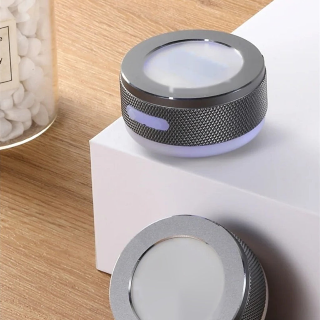 Two SONVEX Pulse speakers placed on a wooden desk next to a white block